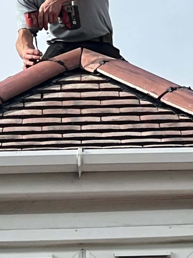 This is a photo of one of the operatives of TRP Roofing Hessle installing new ridge tiles