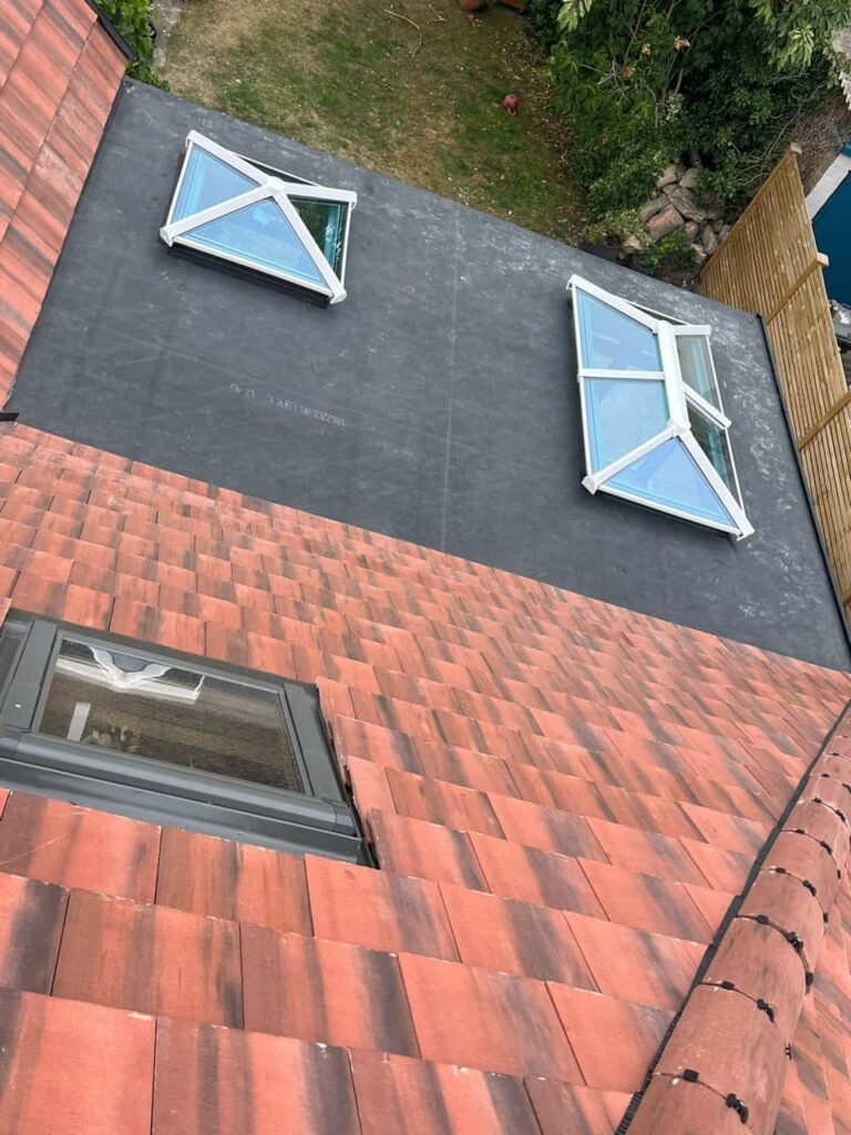 This is a photo taken from the roof ridge looking down a tiled pitched roof on to a flat roof. Works carried out by TRP Roofing Hessle